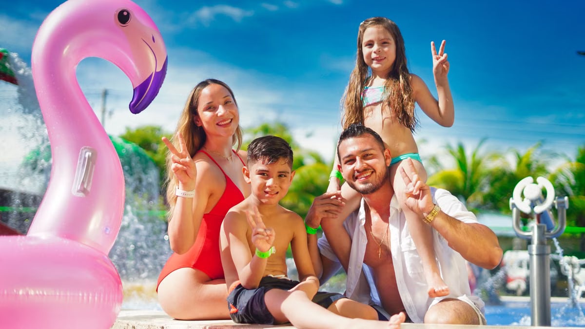 Family enjoying a sunny day by the pool with a pink flamingo float, creating joyful memories.